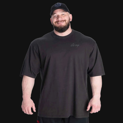 Man wearing a black t-shirt with a logo on a transparent background